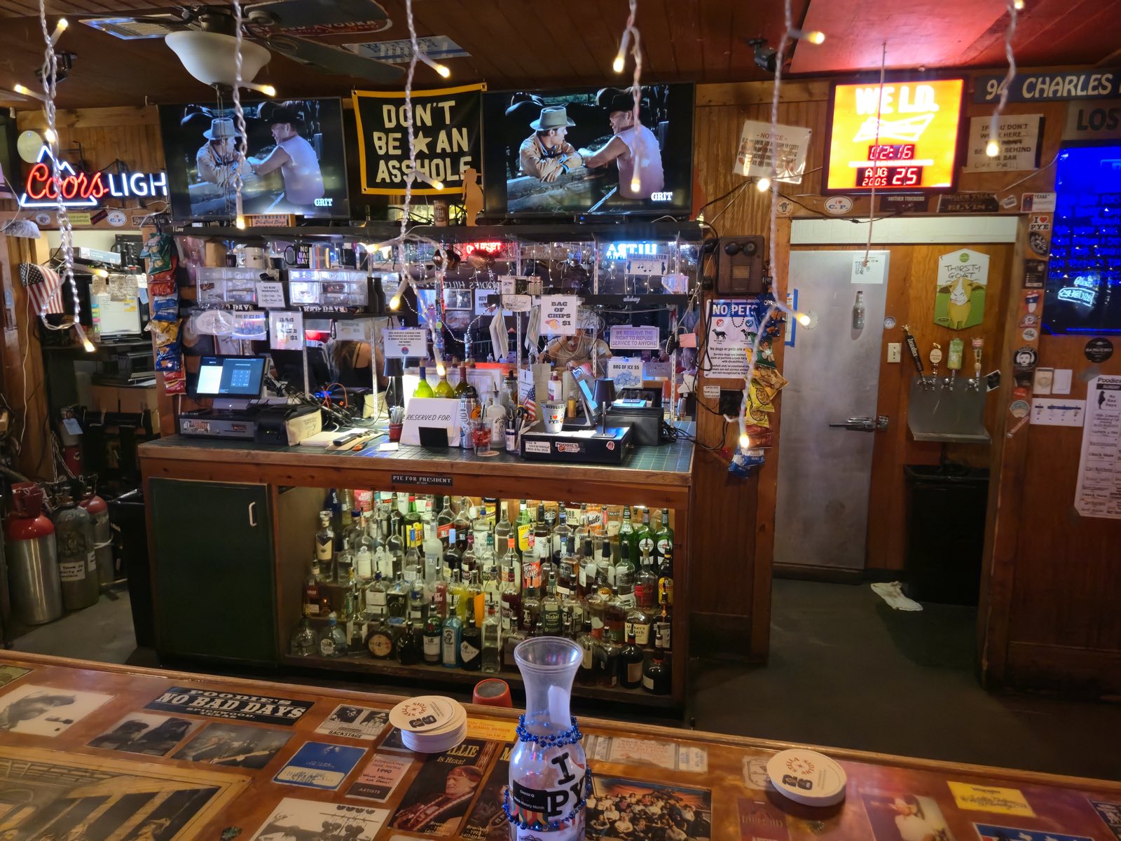 The bar at Poodie's, lined with stools and stacked with bottles