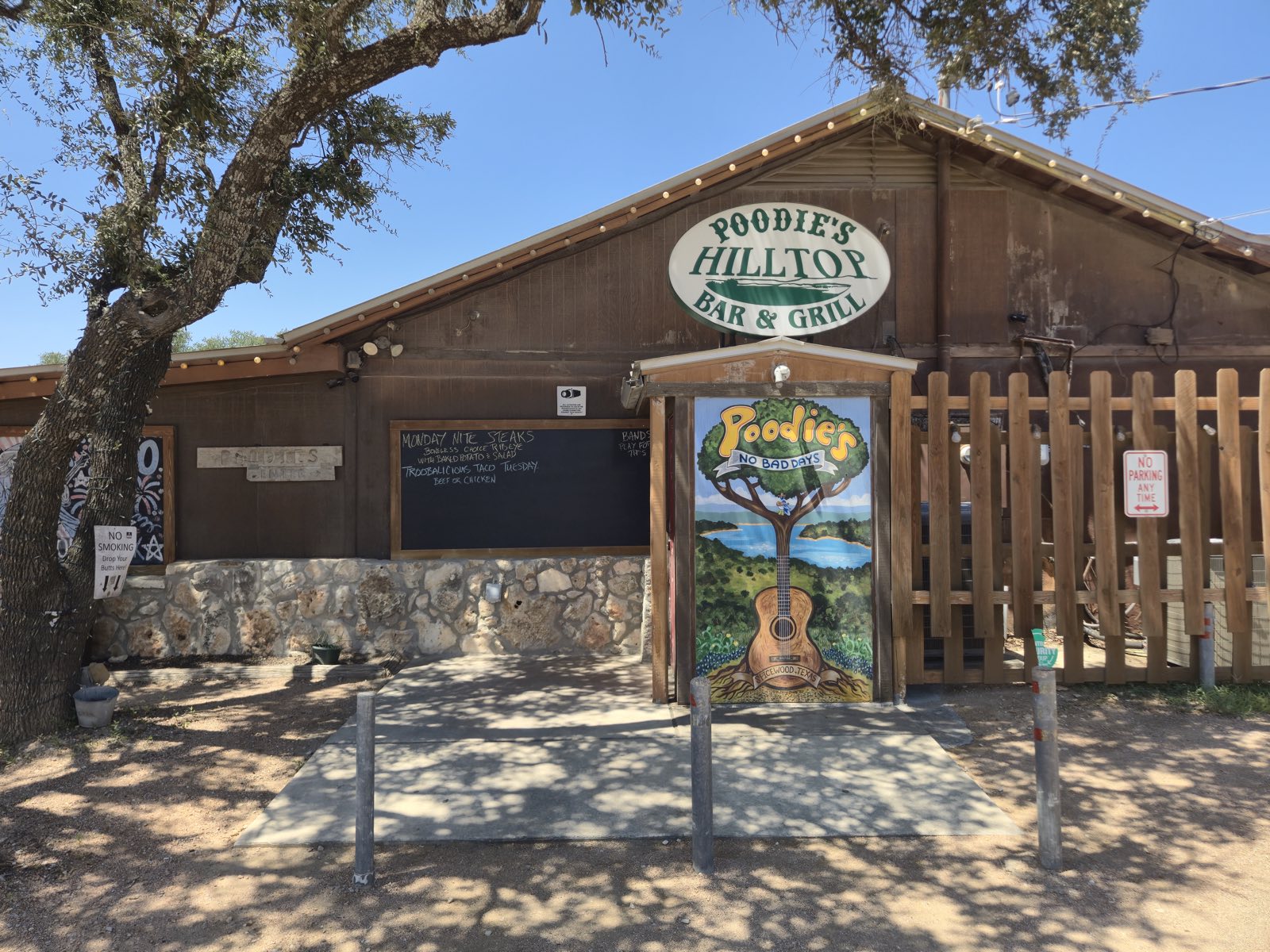 The carved Poodie's Hilltop Bar & Grill sign above the front entrance